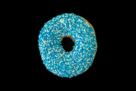 Blue donut. One donut with blue and white decoration isolated on black color background. Top viewの写真素材