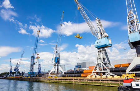 Import export logistics business. Huge cranes at international port of Rotterdam Netherlands, sunny summer dayの写真素材