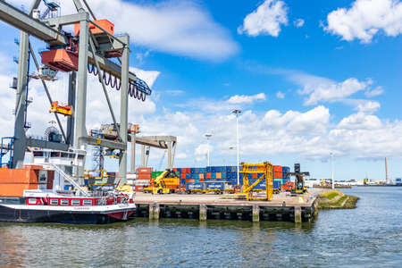 Rotterdam harbor, Netherlands. July 2nd, 2019. Logistics business. Huge cranes and ships anchored at...