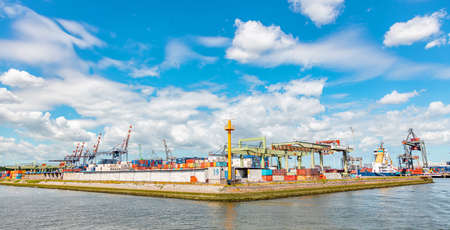 Rotterdam port, Netherlands. July 2nd, 2019. Panorama of international Rotterdam harbor, sunny day. Logistics business. Containers and huge cranes, bannerのeditorial素材