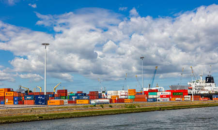 Rotterdam harbor, Netherlands. July 2nd, 2019. Logistics business. Stacked containers and huge bridge cranes, international port of Rotterdam, sunny summer dayのeditorial素材