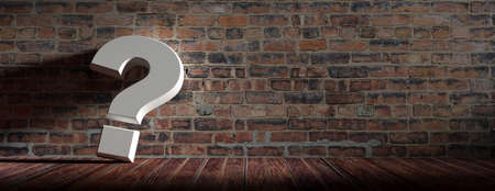 Question mark on wooden floor and vintage brick wall background. Interior decoration concept....