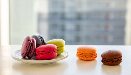 Macarons pastel colors on white table, blur background, close up view with details, copy spaceの写真素材