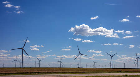 Wind farm, Texas, USA. Wind turbines, alternative energy plant on a green field, sunny spring day
