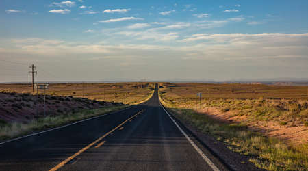 Highway in a sunny spring day, countryside USA. Empty national road, passing through American...