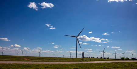 Wind farm, Texas, USA. Wind turbines, alternative energy plant on a green field, sunny spring day