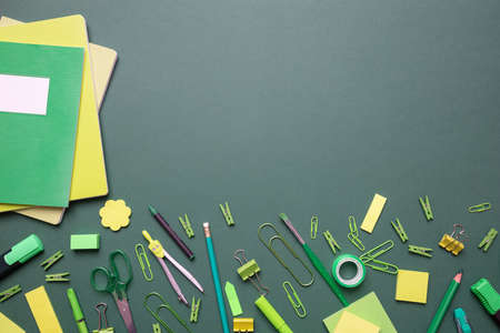 Back to school. School supplies green and yellow color on gray background, top view, copy spaceの写真素材