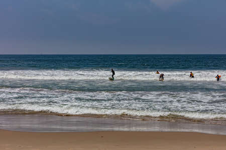 California USA. May 30, 2019. Surfing in Venice beach, Surfers with colorful surfboards and sea ocean waves, blue sky in a sunny spring dayのeditorial素材