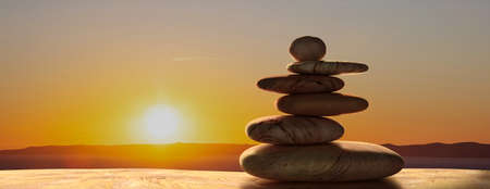 Zen stones stack against sunset nature background.  Harmony, balance concept, banner. 3d...