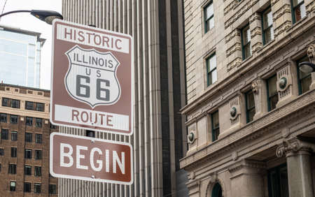 Route 66 Illinois Begin road sign at Chicago city downtown. Buildings facade background. Route 66,...