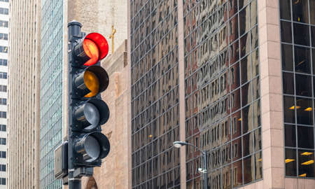 Stop sign. Red traffic lights for cars, office high rise buildings background, Chicago city, Illinois downtownの写真素材