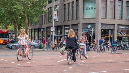 Utrecht Netherlands. July 1st, 2019. People riding bikes in the city center, Spring sunny dayのeditorial素材