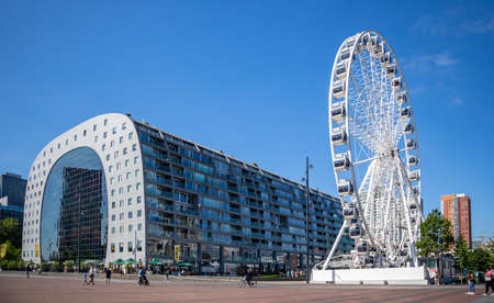 Rotterdam, Netherlands. June 27, 2019.  Market Markthal exterior view, ferris wheel and people, spring sunny dayのeditorial素材