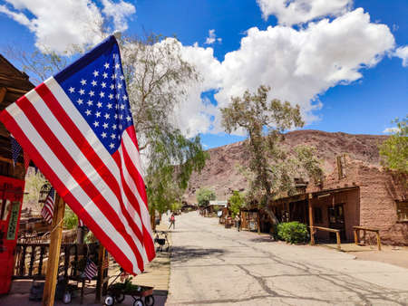 Calico Ghost Town California, USA. May 29, 2019. US flag waving, Calico theme park background, blue sky, sunny spring dayのeditorial素材