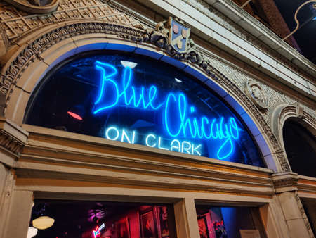 Chicago, Illinois USA. May 10, 2019.  Blue Chicago on Clark jazz club Neon blue sign with emblems background.のeditorial素材