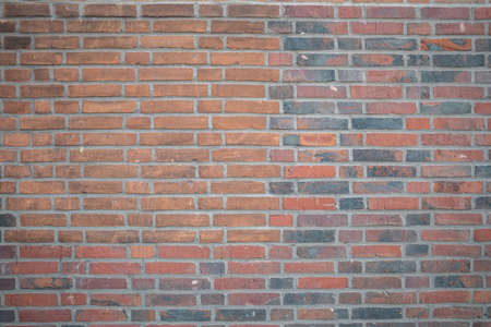 Brown red color brick wall texture, background, aged and faded, traditioanal building facadeの写真素材