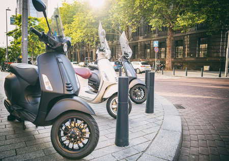 Scooter vintage italian moto. City transportation retro vehicles parked on a sidewalk in Rotterdam city centerの写真素材
