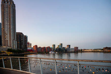 Rotterdam Netherlands June 29, 2019. Rotterdam city waterfront skyscrapers, reflections on the water, sunset time, blue clear sky. View from the bridgeのeditorial素材