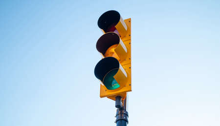 Go sign. Green traffic light for cars, blue sky background