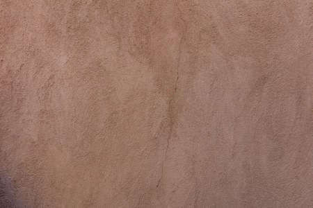 Wall plastered and painted background texture. Exterior building wall facade brown color blank...