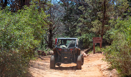 Sedona Arizona USA. May 25, 2019. 4 wheel drive jeep car off road on red orange rocks, green trees backgroundのeditorial素材