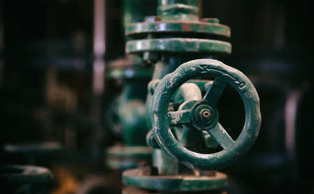 Industrial pipeline and valve close up, blur background. Old rusty control equipment, fuel plant industryの写真素材