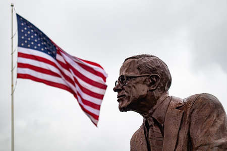 Saint Louis Missouri, US of America, May 12, 2019. Statue of Malcolm Martin and US flag waving against cloudy sky in a spring dayのeditorial素材