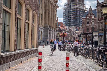 Utrecht, Netherlands - JULY 01, 2019: People walking and riding bike on paved pedestrian street in old town on sunny dayのeditorial素材
