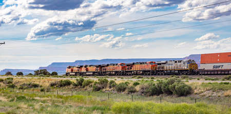 Arizona, USA. May 17, 2019. Freight  BNSF train in Chinle, canyon de Chelly rocks background, sunny spring dayのeditorial素材