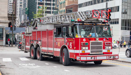 Chicago, Illinois, US. May 9, 2019: Back to school. School bus yellow color on the road, city center, spring morningのeditorial素材