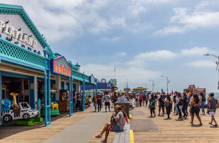Santa Monica, Los Angeles California USA. May 31, 2019. Tourists colorful crowd walking on Santa Monica pier, blue sky, sunny spring dayのeditorial素材