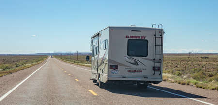 Arizona highway, USA. May 25, 2019: RV recreational vehicle  rear view on the highway, desert landscape, blue skyのeditorial素材