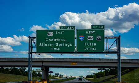 Oklahoma highway, USA. May 29, 2019: Road sign, informative, green color billboard on the highway, blue cloudy skyのeditorial素材