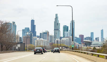 Chicago Illinois, USA. May 8th, 2019. Cars on the road driving to Chicago city, high rise buildings and cloudy sky backgroundのeditorial素材