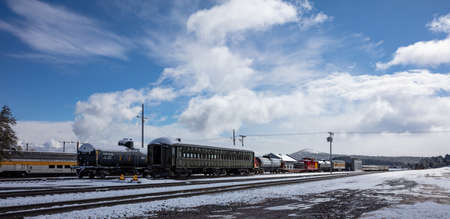 Williams Arizona USA. May 23, 2019. Retro historic trains at the station. Snowy day, Tracks and wagons covered with snowのeditorial素材