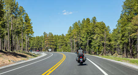 Arizona highway, USA. May 26, 2019: Rear view of a biker riding a moto, highway near Sedona,  blue sky, sunny spring dayのeditorial素材