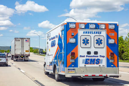 Chicago Illinois highway, USA. May 6, 2019: Ambulance rear view on the highway, sunny spring day, blue skyのeditorial素材