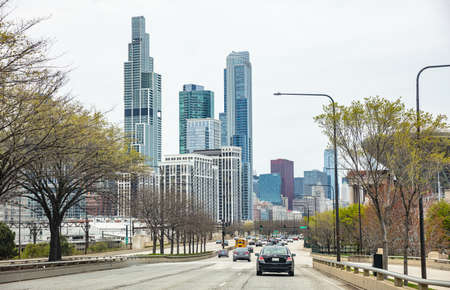 Chicago Illinois, USA. May 8th, 2019. Cars on the road driving to Chicago city, high rise buildings and cloudy sky backgroundのeditorial素材