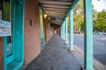 Santa Fe city, New Mexico USA. May 15, 2019. Traditional building with covered walkway and blue columns in Santa Fe downtown, sunset timeのeditorial素材