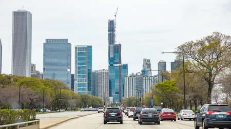 Chicago Illinois, USA. May 8th, 2019. Cars on the road driving to Chicago city, high rise buildings and cloudy sky backgroundのeditorial素材