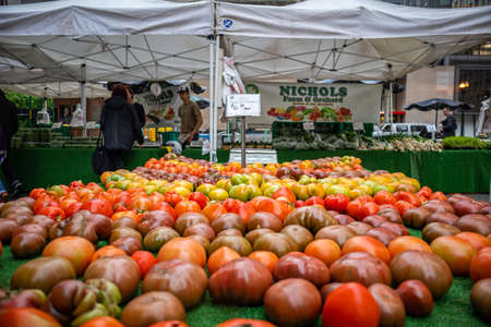 Chicago, Illinois, USA, May 9, 2019. Farmers market stalls with fresh vegetables proper for diet, vegan, vegetarian. Tent covers and protects consumers and workers.のeditorial素材