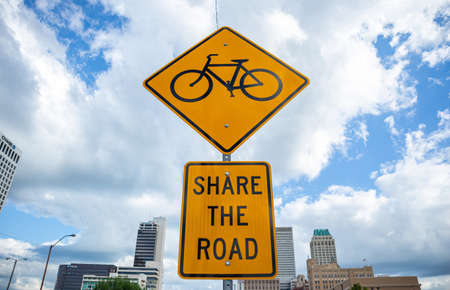 Tulsa, Oklahoma, USA. May 13, 2019.Share the road sign. Cars and bikes together at Tulsa's streets. Cloudy city background.のeditorial素材