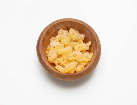 Mastic resin tears. Chios mastic in a wooden bowl isolated on white backgroundの写真素材