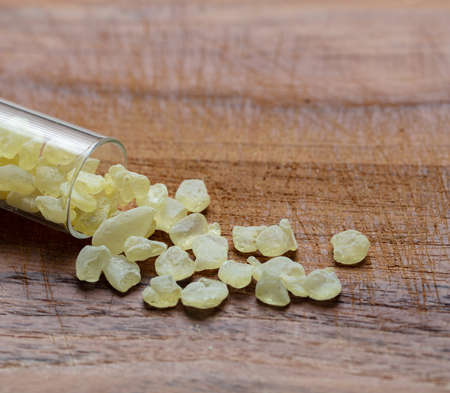 Mastic resin tears. Chios mastic on wood background, closeup viewの写真素材