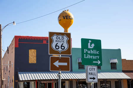 Tucumcari, New Mexico, USA. May 14, 2019. Old Route 66, city hall and Public Library signs with directions. Traditional building and blue sky background.のeditorial素材