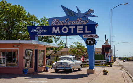 Tucumcari, New Mexico, USA. May 14, 2019. Motel Blue Swallow next to mother road, route 66, a sunny day. An antique car is parked at the entrance.のeditorial素材