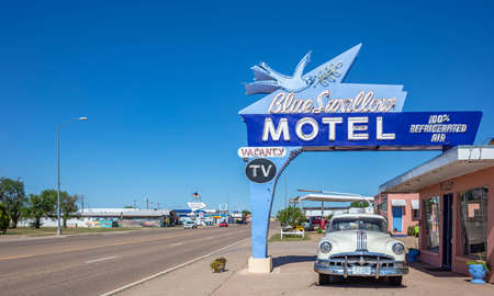 Tucumcari, New Mexico, USA. May 14, 2019. Motel Blue Swallow next to mother road, route 66, a sunny day. An antique pontiac car is parked at the entrance.のeditorial素材