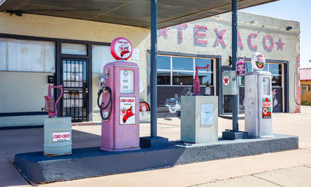 New Mexico, USA. May 14, 2019. Old-fashioned fuel pumps at gas station next to historic route 66. Building with logo background.のeditorial素材