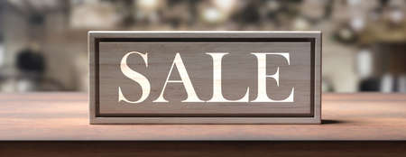 Sale concept. SALE text on a wood block sign on a wooden table, blur interior background, banner. 3d...