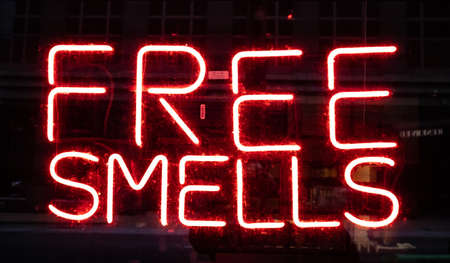 St Louis, USA. May 12, 2019. Free Smells Neon Sign. Electric red letters on glass board advertise at night the store. Close up view with details.のeditorial素材